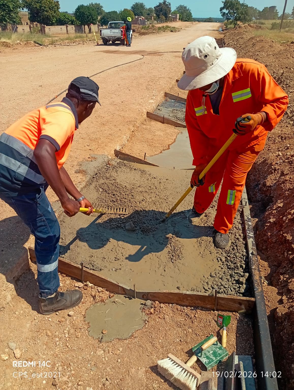 CPS construction team working together on a concrete drainage channel